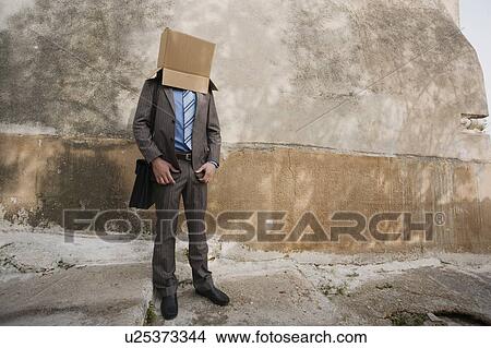 Picture - Businessman with head in a box. Fotosearch