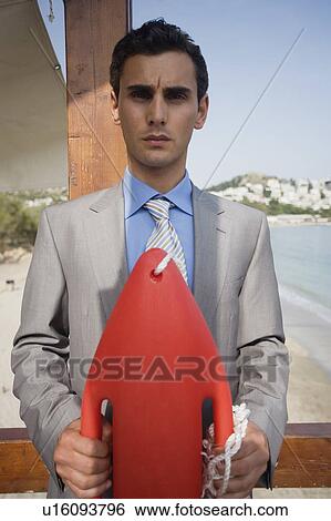 Businessman with life preserver View Large Photo Image Stock Photograph - Businessman with life preserver. Fotosearch