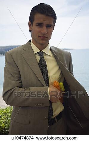 Picture - Businessman with plastic water gun. Fotosearch