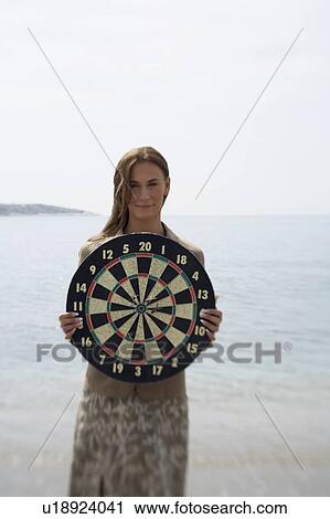 Businesswoman on beach with dartboard View Large Photo Image Stock Image - Businesswoman on beach with dartboard. Fotosearch