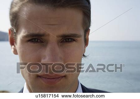 Picture - Closeup of businessman on the beach. Fotosearch