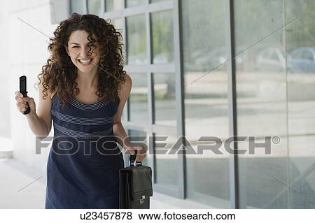Happy businesswoman with cell phone View Large Photo Image Stock Photo - Happy businesswoman with cell phone. Fotosearch