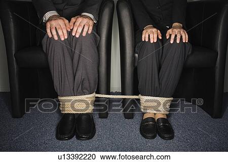 Male and female business people's legs tied View Large Photo Image Stock Image - Male and female business people's legs tied. Fotosearch