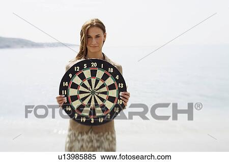 Businesswoman on beach with dartboard View Large Photo Image Stock Photography - Businesswoman on beach with dartboard. Fotosearch