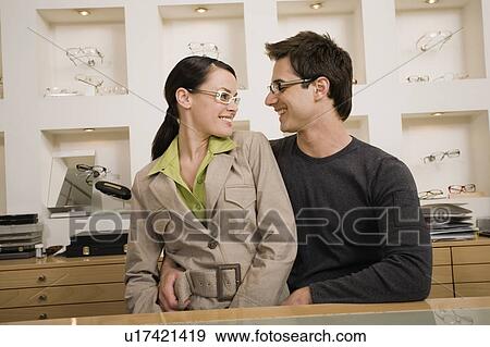 Stock Photo - Couple posing with eyeglasses in store. Fotosearch