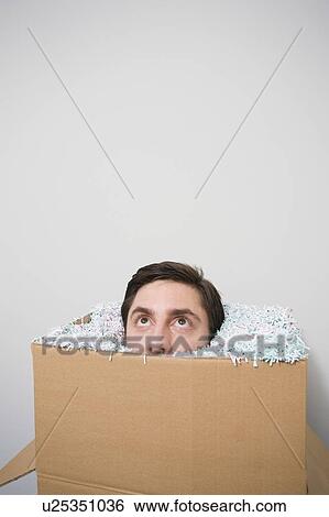 Stock Photograph - Office worker with head in a box. Fotosearch