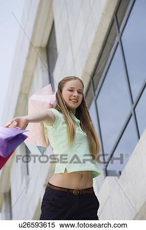 Stock Photography - Woman swinging shopping bags. Fotosearch