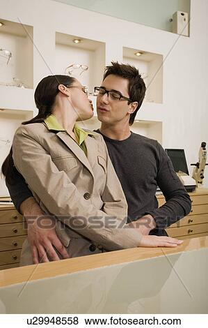 Couple about to kiss in eyeglasses store View Large Photo Image Stock Photo - Couple about to kiss in eyeglasses store. Fotosearch