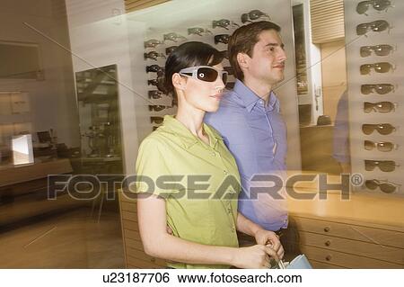 Couple shopping in sunglasses store View Large Photo Image Stock Photograph - Couple shopping in sunglasses store. Fotosearch
