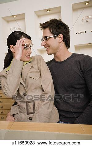 Stock Photo - Couple with eyeglasses in store. Fotosearch