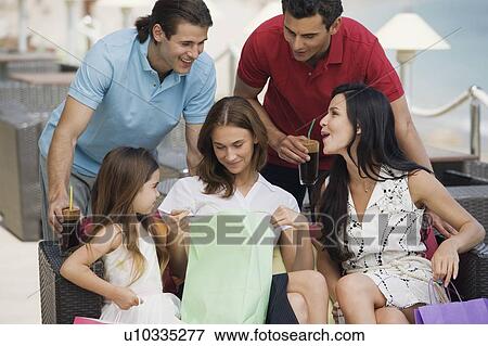 Two couples and child with shopping bags View Large Photo Image Stock Photo - Two couples and child with shopping bags. Fotosearch