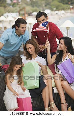 Stock Photo - Two couples and child with shopping bags. Fotosearch