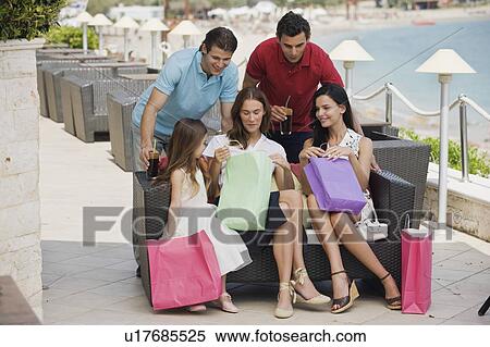 Stock Photography - Two couples and child with shopping bags. Fotosearch