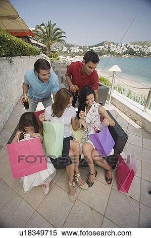 Stock Photography - Two couples and child with shopping bags. Fotosearch