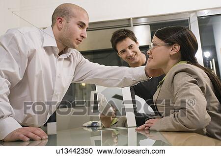 Stock Image - Woman trying on glasses in store. Fotosearch