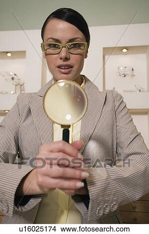 Woman with magnifying glass in store View Large Photo Image Picture - Woman with magnifying glass in store. Fotosearch