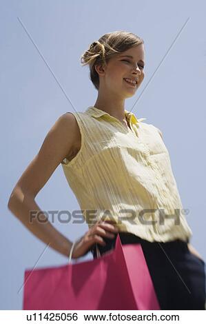 Woman with shopping bag posing View Large Photo Image Stock Photograph - Woman with shopping bag posing. Fotosearch
