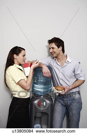 Male and female office workers eating take out food View Large Photo Image Picture - Male and female office workers eating take out food. Fotosearch