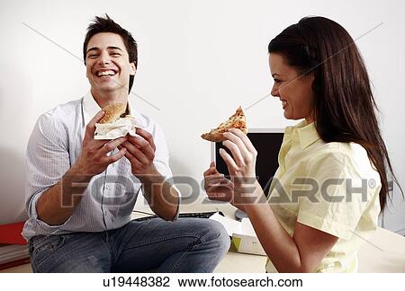 Male and female office workers eating take out food View Large Photo Image Stock Image - Male and female office workers eating take out food. Fotosearch