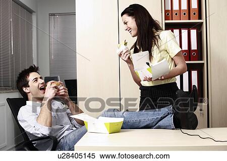 Male and female office workers eating take out food View Large Photo Image Stock Photography - Male and female office workers eating take out food. Fotosearch
