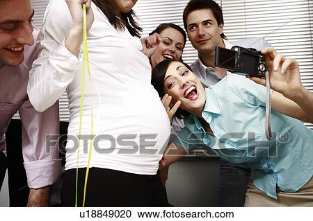Office colleagues photographing at party with pregnant colleague View Large Photo Image Stock Image - Office colleagues photographing at party with pregnant colleague. Fotosearch