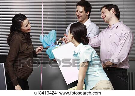 Picture - Pregnant office worker receiving presents at party. Fotosearch