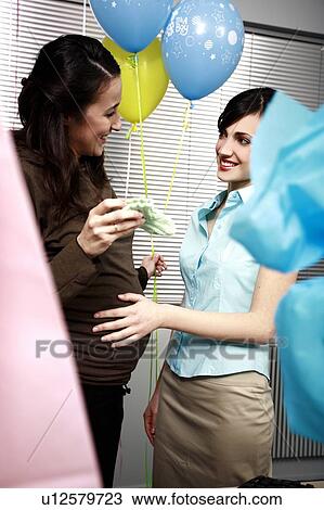 Pregnant office worker with colleague at party View Large Photo Image Stock Image - Pregnant office worker with colleague at party. Fotosearch