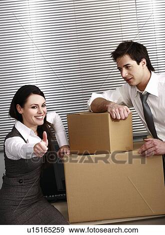 Business people in office with boxes View Large Photo Image Stock Photo - Business people in office with boxes. Fotosearch