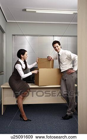 Stock Photo - Business people in office with boxes. Fotosearch