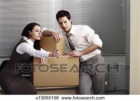 Stock Photograph - Business people in office with boxes. Fotosearch