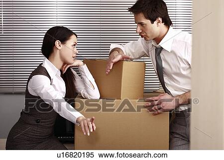 Stock Photography - Business people in office with boxes. Fotosearch
