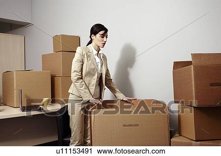 Businesswoman among boxes View Large Photo Image Stock Image - Businesswoman among boxes. Fotosearch