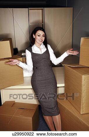Businesswoman among boxes View Large Photo Image Stock Image - Businesswoman among boxes. Fotosearch