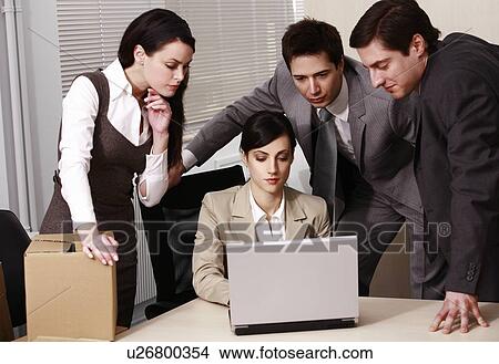 Picture - Four business people in office. Fotosearch