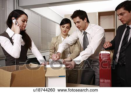 Four business people unpacking boxes in office View Large Photo Image Stock Image - Four business people unpacking boxes in office. Fotosearch