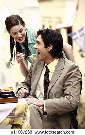 Stock Photo - Business couple at taverna. Fotosearch