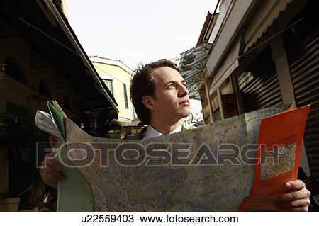 Stock Image - Businessman with a map. Fotosearch