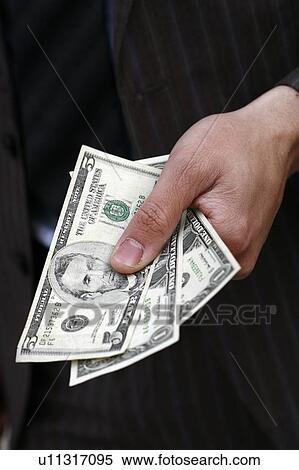 Closeup of hand holding dollars View Large Photo Image Stock Photography - Closeup of hand holding dollars. Fotosearch