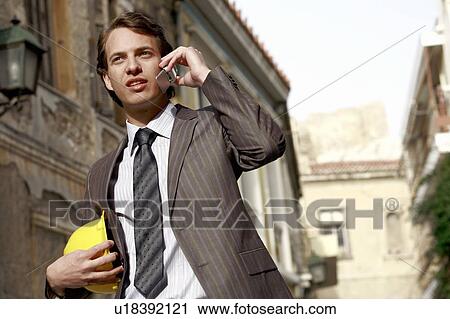Stock Image - Man in suit with hard hat. Fotosearch