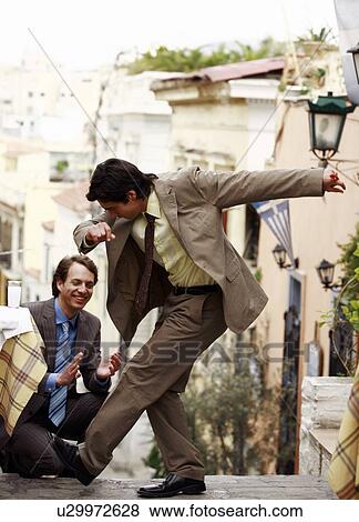 Two businessmen Greek dancing View Large Photo Image Stock Photo - Two businessmen Greek dancing. Fotosearch