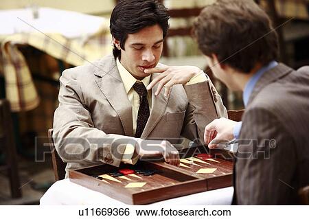 Two businessmen playing backgammon View Large Photo Image Stock Photograph - Two businessmen playing backgammon. Fotosearch
