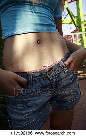 Closeup of female teenager's pierced belly button at amusement park View Large Photo Image Stock Photograph - Closeup of female teenager's pierced belly button at amusement park. Fotosearch