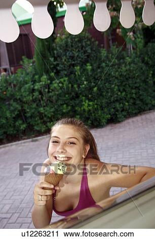 Female teenager eating an ice cream cone View Large Photo Image Stock Image - Female teenager eating an ice cream cone. Fotosearch