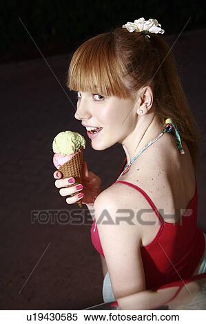 Female teenager eating an ice cream cone View Large Photo Image Stock Photography - Female teenager eating an ice cream cone. Fotosearch