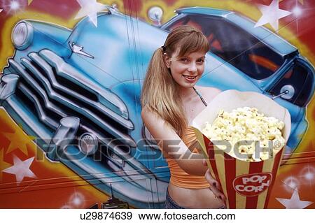 Stock Photo - Female teenager posing in amusement park. Fotosearch