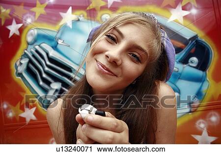Female teenager with mp3 player in front of graffiti View Large Photo Image Stock Image - Female teenager with mp3 player in front of graffiti. Fotosearch