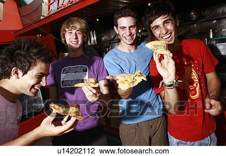 Male teenagers hanging out, eating pizza View Large Photo Image Stock Image - Male teenagers hanging out, eating pizza. Fotosearch