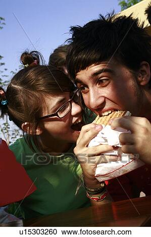 Teenage couple eating one grilled cheese View Large Photo Image Stock Image - Teenage couple eating one grilled cheese. Fotosearch