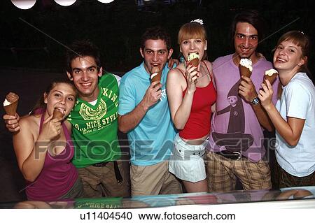 Stock Image - Teenagers eating ice cream. Fotosearch