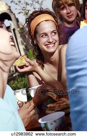 Teenagers hanging out, eating View Large Photo Image Stock Image - Teenagers hanging out, eating. Fotosearch